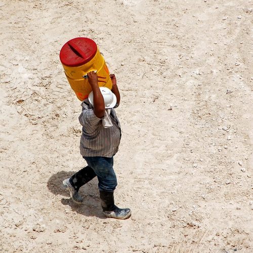 construction worker holding water jug